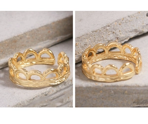 Close-up of S925 silver stamp on gold pleated texture wavy hollowed open ring