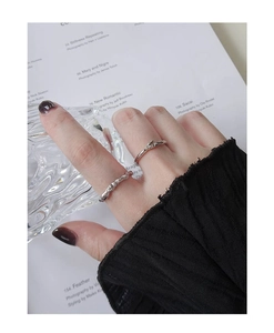 Detail of minimalist S925 sterling silver rings with irregular lava texture and branch design