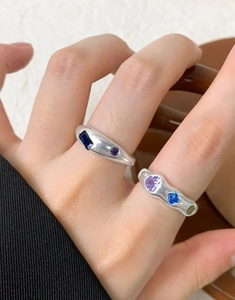 Close-up of S925 silver rings featuring irregular textures and colorful cubic zirconia