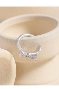 Detailed view of an S925 sterling silver bow ear cuff with white cubic zirconia pavé