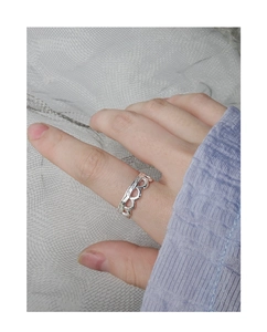 Detail of S925 silver wavy textured ring shown on a hand with minimalist lace design