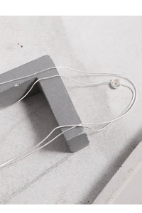 Minimalist S925 silver double-layered snake chain necklace on a gray geometric prop