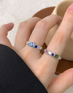 Macro detail of S925 silver wavy rings with colorful baguette-cut zircon gemstones
