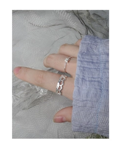 Close-up of S925 sterling silver rings with pleated texture and wavy hollow design