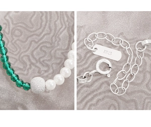 Detailed close-up of S925 silver lobster clasp and green crystal beads on necklace
