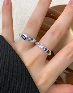 Close-up of S925 sterling silver rings with colorful inset zircons and irregular design