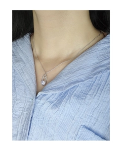 Close-up of S925 silver heart padlock necklace with purple zircon on woman neck