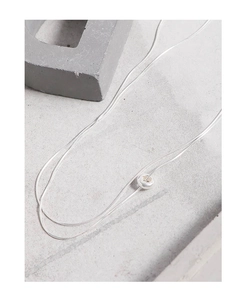 Detailed close-up of double layer silver snake chain necklace with minimalist circle pendant