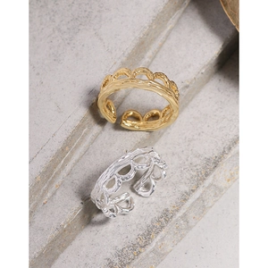 Minimalist S925 silver wavy open rings in gold and silver finish on stone display