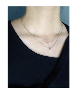 Close-up of a double-layered S925 sterling silver snake chain with round pendant