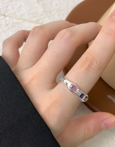 Detail of silver S925 ring with pink purple green gems and SE engraving on band