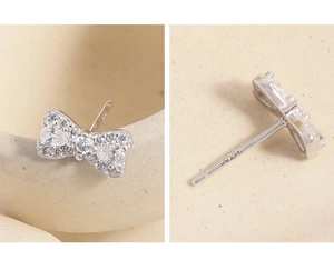 Detailed view of S925 sterling silver bow earrings with micro-pave cubic zirconia