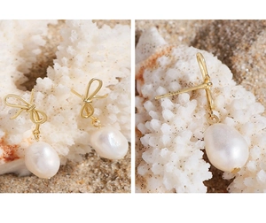 Detail of S925 silver stamp and baroque pearl drop on elegant golden bow earrings
