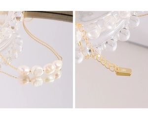 Close-up of S925 sterling silver tag and baroque pearls on minimalist gold chain