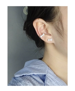 Close-up of S925 silver bow stud earring and ear cuff set with sparkling zircon stones