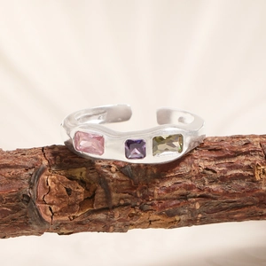 S925 sterling silver geometric open ring with three colored zircons on a wooden branch