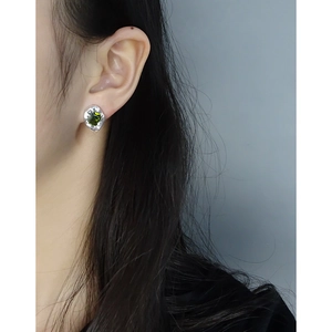 Elegant S925 silver stud earring featuring an emerald-cut green zircon on model's ear