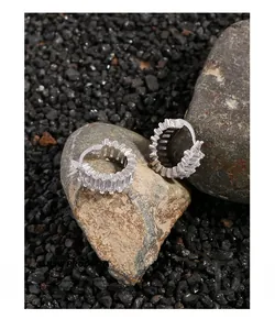 Macro detail of S925 silver hoop earrings with baguette-cut pavé cubic zirconia