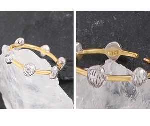 Detail of S925 hallmark on minimalist two-tone open ring with textured meteorite beads