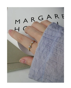 Detail of S925 silver ring featuring gold band and irregular hammer texture beans