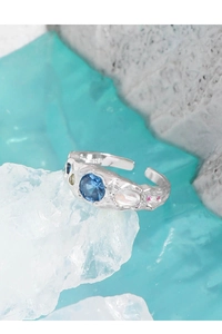 Macro detail of S925 sterling silver ring with blue zircon and lava texture finish