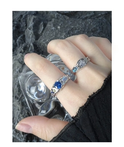 Detail of S925 silver rings with blue zircon and moonstone on hammered texture band