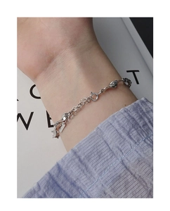 Close-up of S925 sterling silver Mobius bracelet featuring minimalist twisted metal plates