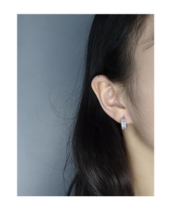 Close-up of minimalist S925 silver hoop earrings with micro-set square cubic zirconia