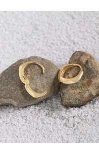 Detail of gold geometric hoop earrings with hinge mechanism on natural dark stones