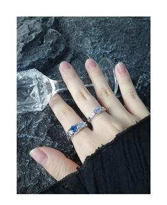 Detail of vintage S925 silver rings with blue zircon and moonstone on hand