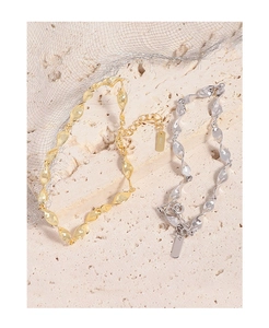Detail view of gold and silver S925 Mobius bracelets with elegant twisted metal texture