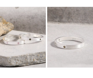 Detailed macro view of S925 sterling silver brushed texture rings with pink and green stones