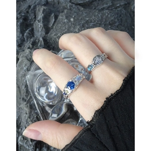 S925 sterling silver rings with blue zircon, lava texture finish on a stone background