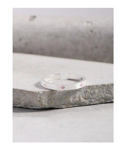 Macro detail of S925 sterling silver brushed ring with pink cubic zirconia stones