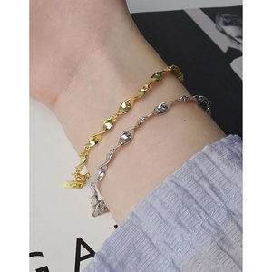 S925 sterling silver Mobius twist bracelets in gold and silver finish on a female wrist