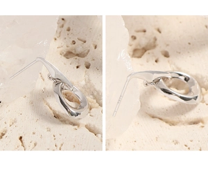 Macro detail of irregular S925 sterling silver earrings with hallmark and polished finish
