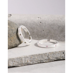 Minimalist S925 sterling silver brushed rings with zircons on stone background