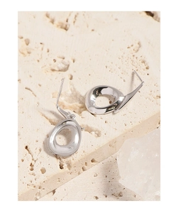 Macro shot of S925 sterling silver stamp on minimalist irregular silver stud earrings