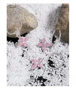 Macro shot of silver S925 necklace and earrings set with pink zircon flower petals