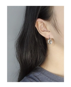 Close-up of minimalist S925 sterling silver irregular round stud earrings on female ear