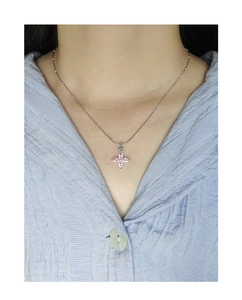 Detail of S925 sterling silver necklace with pink clover pendant on a female model