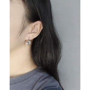 Minimalist S925 sterling silver irregular hoop earrings shown on a model side view