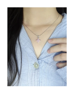 Close-up of S925 silver necklace with pink zircon cherry blossom pendant on neck