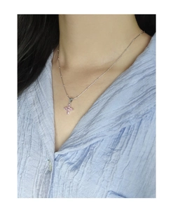 Macro shot of S925 sterling silver necklace with pink cherry blossom zircon pendant