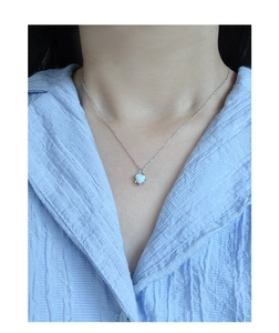 Close-up of S925 sterling silver necklace with a heart opal pendant on a model