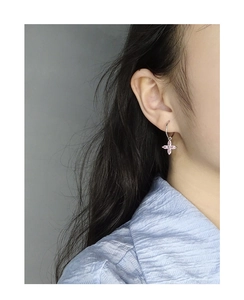 Gros plan sur la boucle d'oreille en argent S925 avec breloque fleur de cerisier en zircon
