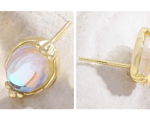 Detailed view of S925 sterling silver stamp and moonstone inlay on gold-plated earring