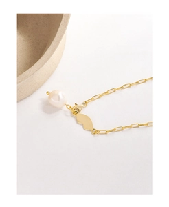 Detailed close-up of S925 silver gold-plated paperclip chain with baroque pearl and butterfly wing