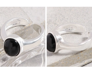 Detail showing S925 hallmark on minimalist silver ring with black onyx stone