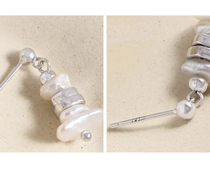 Detail of baroque pearl drop earrings with S925 silver studs and irregular metal spacers